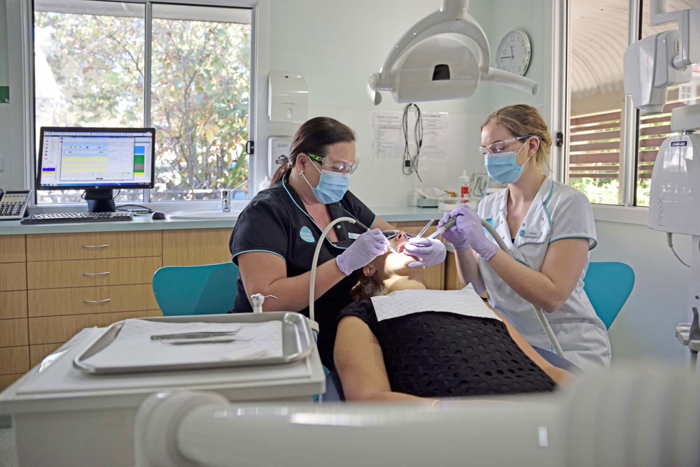 Two Maven Dental clinicians with a patient