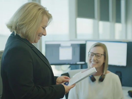 Clair speaking to woman at the Maven Dental Support Centre 