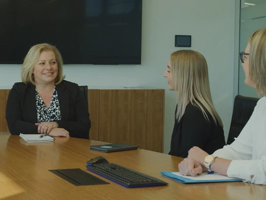 Maven Support Center staff in board room meeting 