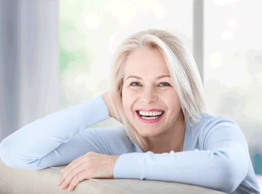 Mature Women wearing blue shirt while smiling