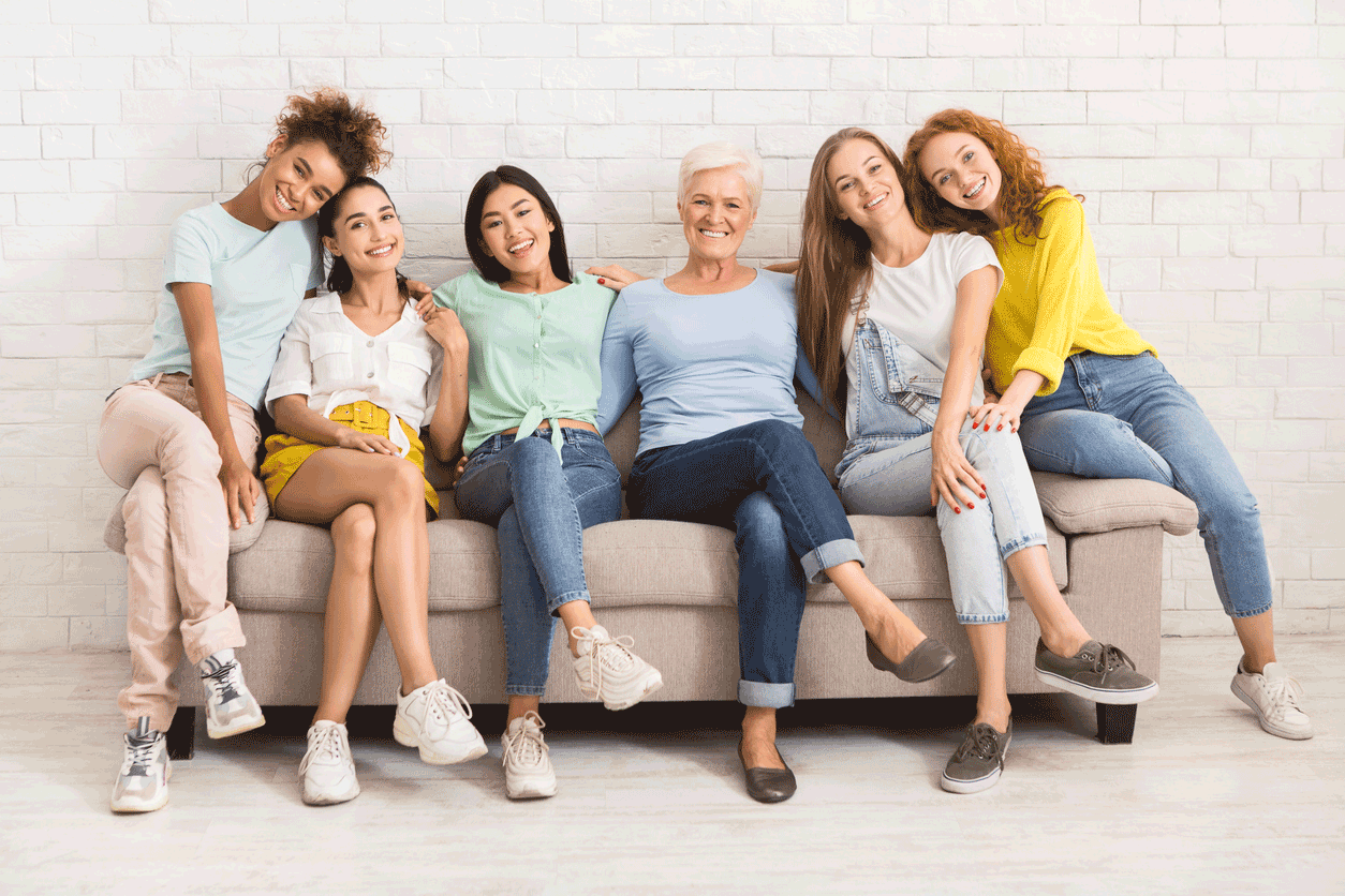 Group of women smiling while sitting on lounge 
